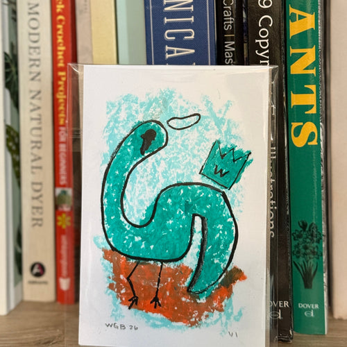 Book with a green dinosaur illustration on a shelf with other books